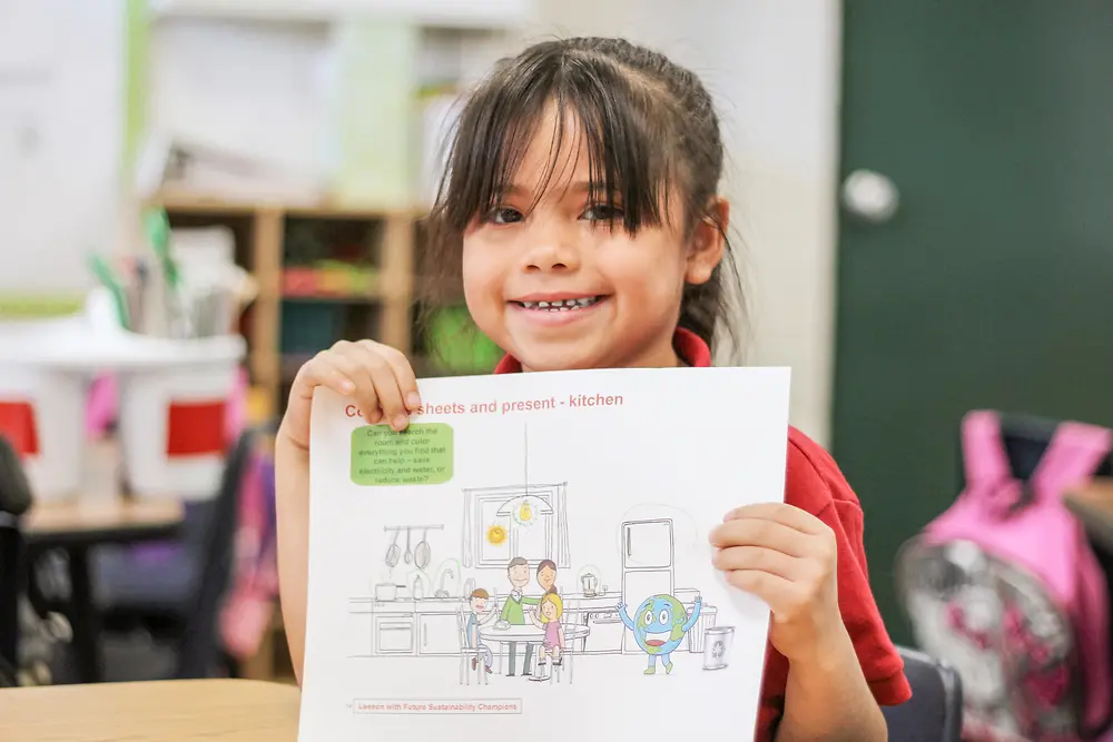 girl holding sustainability teaching materials